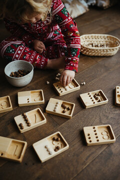 Toddler learning how to count with wooden toy