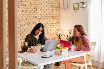 Lesbian couple working remotely from home