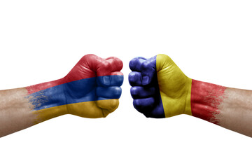 Two hands punch to each others on white background. Country flags painted fists, conflict crisis concept between armenia and romania