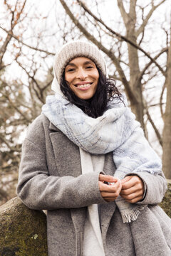 Model wearing wool coat and beanie outdoors