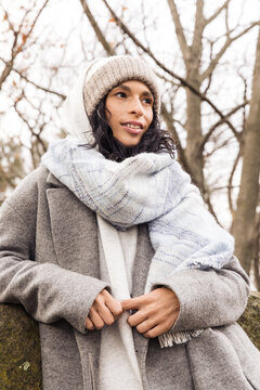 Model wearing wool coat and beanie outdoors