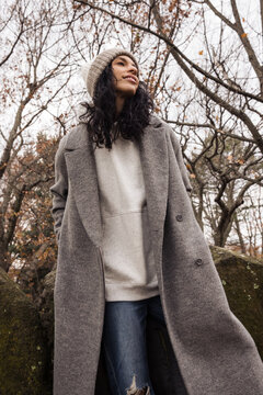 Model wearing wool coat and beanie outdoors