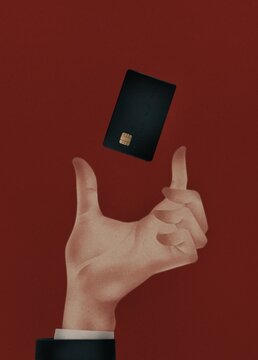 hand holds a bank credit card on a red background