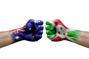 Two hands punch to each others on white background. Country flags painted fists, conflict crisis concept between australia and burundi