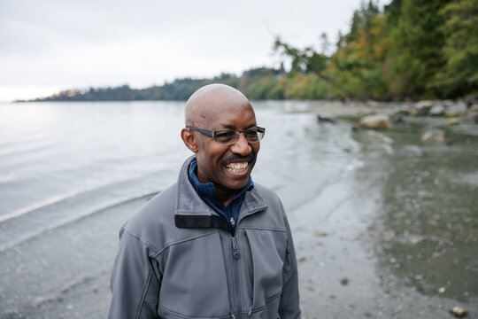 Older man with glasses enjoying being outside.