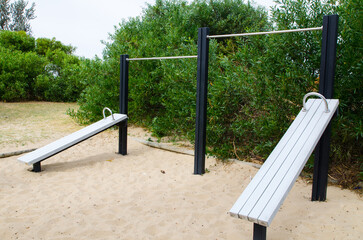 Outdoor fitness equipment for sit-up board in public park.