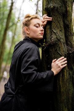 Blonde Woman Leaning Against Tree