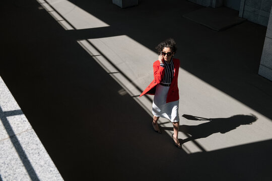 Stylish businesswoman walking on road