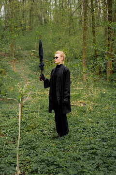 Woman Wearing Black Outfit With Umbrella In Forest 