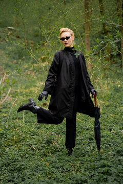 Woman Wearing Black Outfit With Umbrella In Forest 