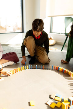 kids doing circuit with colorful dominoes