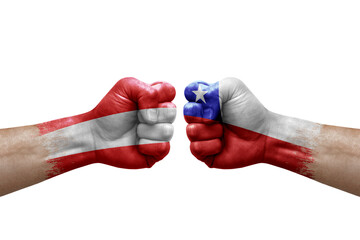Fototapeta premium Two hands punch to each others on white background. Country flags painted fists, conflict crisis concept between austria and chile
