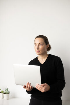 Woman holding open laptop