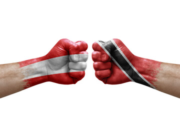 Two hands punch to each others on white background. Country flags painted fists, conflict crisis concept between austria and tobago
