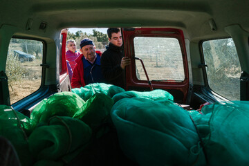 Farmers closing doors of car in countryside