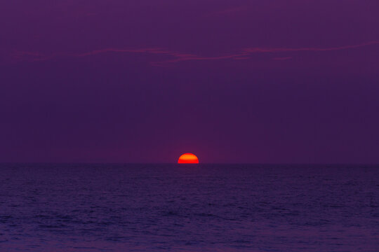 purple sunset with the sun on the middle  in Oaxaca 
