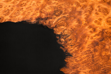 Wooden slab in solid redwood with black epoxy resin. Detail shot. Old growth redwood burl.