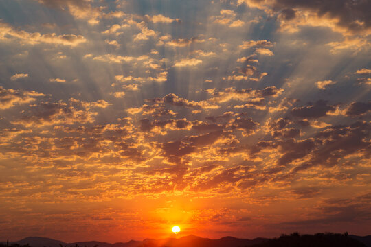 sun in the middle of a sky full of clouds - Powered by Adobe