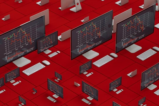 Laptop and desktop computer showing stock market statistics on screen