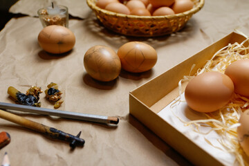 Tools for decorating Paschal eggs, Pysankas. Workplace. Rustic background. Collection of eggs. Homemade pen for drawing eggs. Preparation for holiday. Craft paper. Tradition. Ethnic. Decor. Closeup