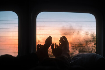 Couple feet inside a van during sunrise