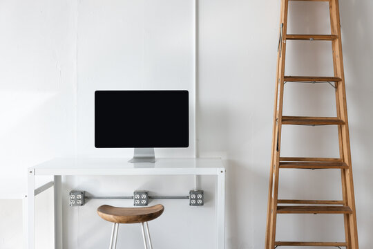 desk with monitor and wood ladder in photo studio 