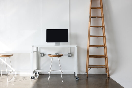 desk with monitor and wood ladder in photo studio 