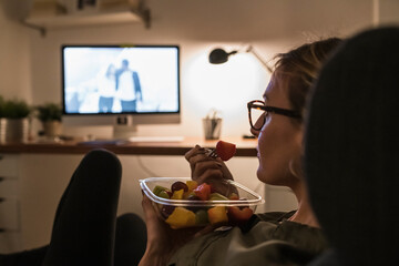 Woman watching a movie at home