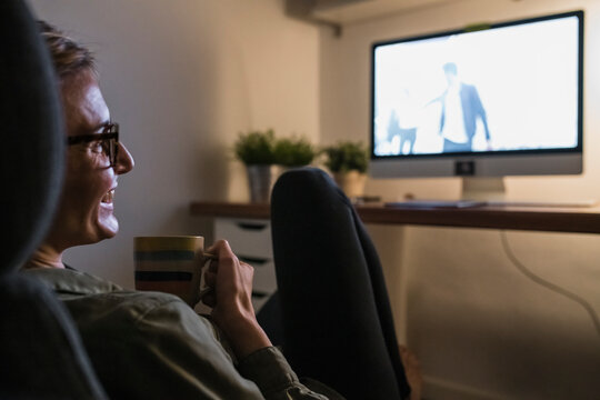 Woman watching a movie at home