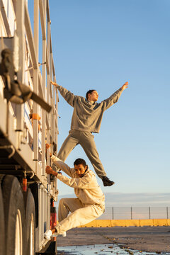 Brave frirends climbing truck 