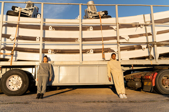 Friends posin in front of parked truck