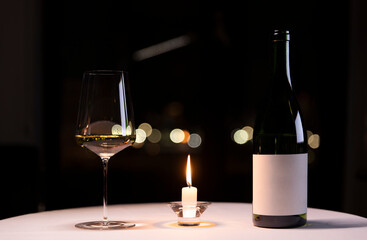 Candlelit table with wine bottle and glass
