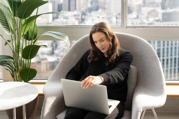 Woman closing laptop computer