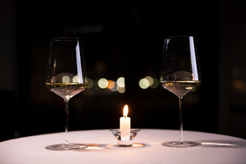 Candlelit Table with Two Glasses of White Wine