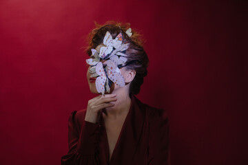 Anonymous woman with butterflies on her face