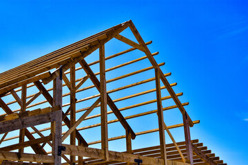 Two story wood frame building under construction.