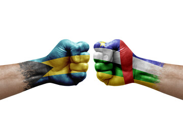 Two hands punch to each others on white background. Country flags painted fists, conflict crisis concept between bahamas and central african republic