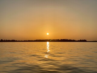 Naklejka premium sunset over the river