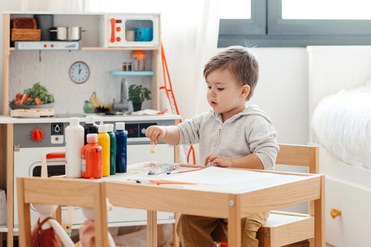 Toddler at drawing table.