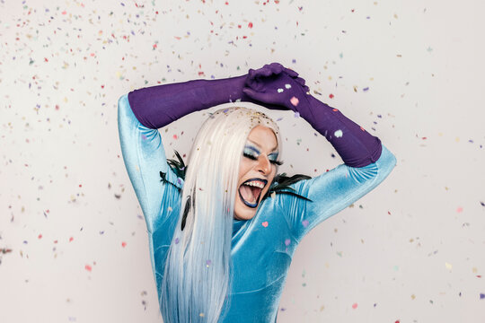 Happy drag queen with bright makeup and confetti