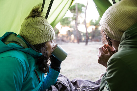 Couple drinking tea in tent