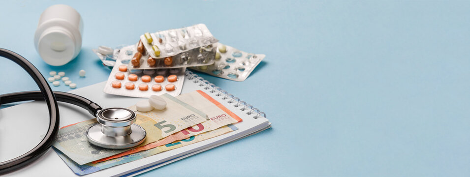 Cost of medicinal products and treatment concept. Copy space. Cost of health care with EURO bank notes, stethoscope and medicaments. Price of medicine. Medical expenses. EURO small bills cash money. 