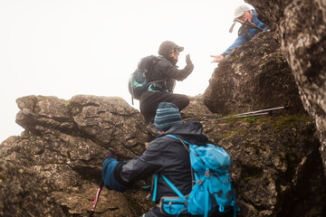 Female hiker refusing friend's help