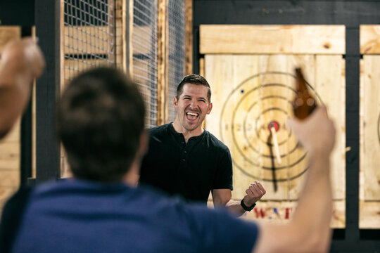 Man Excited After Hitting Bullseye With Axe