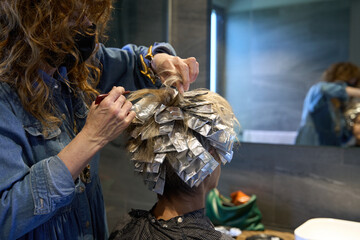 Foils with hair color being applied