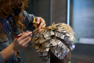 Woman with hair foils applied for colouring hairs