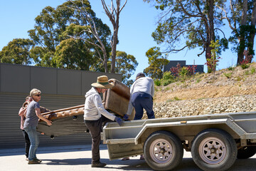 Old sofa lifted onto trailer