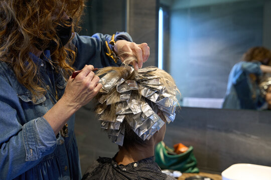 Foils with hair color being applied