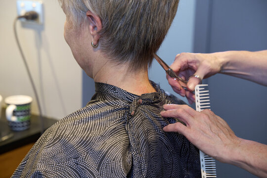 Hairdresser cutting hair at home