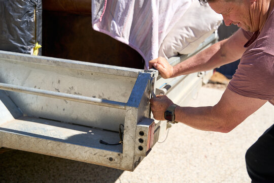 Man latching at trailer tailgate